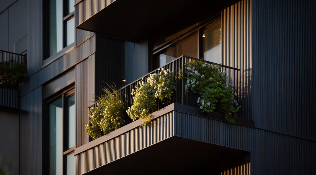Illustration of a person happily tending to a lush balcony garden